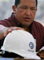 Hugo Chavez reaches for his safety hat